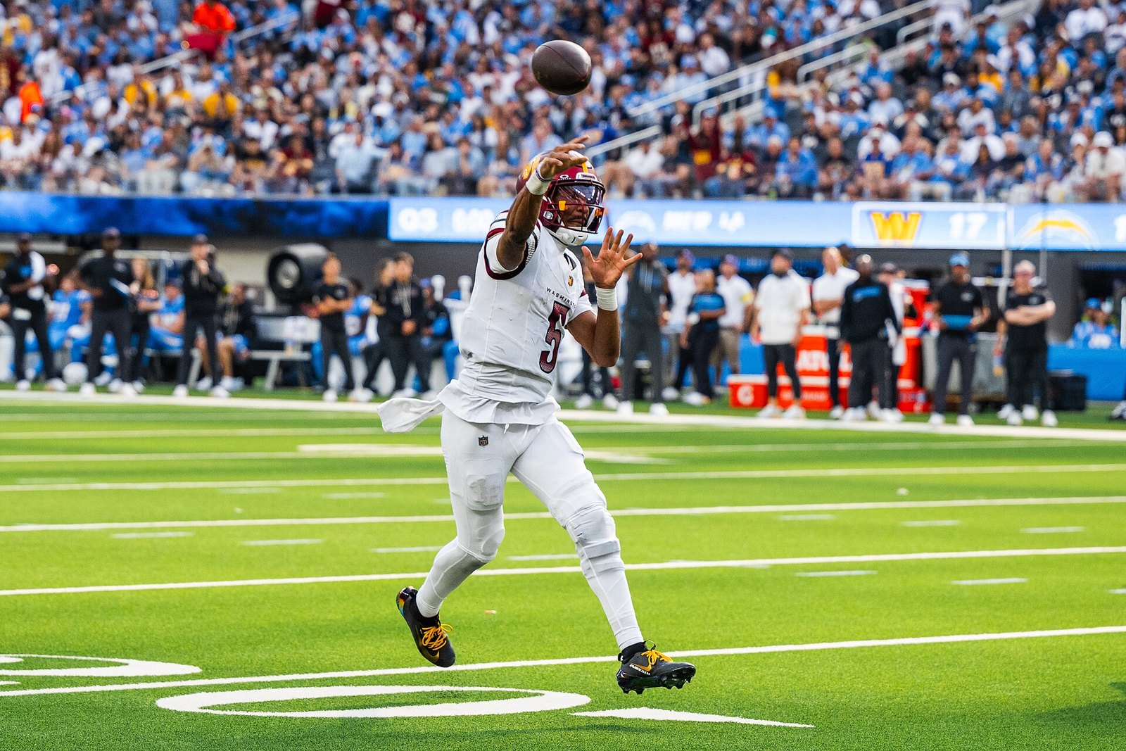 Jayden Daniels of the Washington Commanders in motion against the Los Angeles Chargers, October 2025